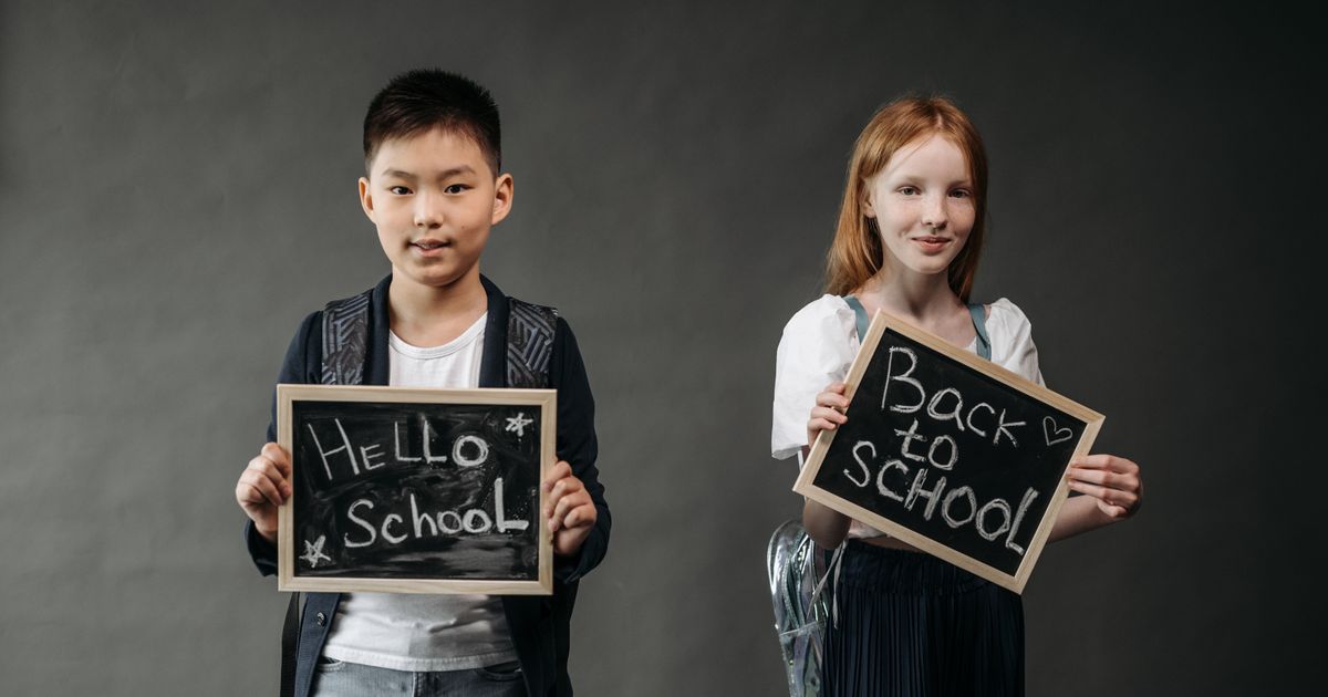 Child with a backpack and school supplies ready for the new school year