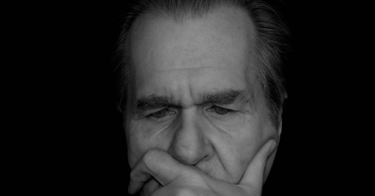 Thoughtful man looking into the distance, illustrating the weight of decisions and potential losses