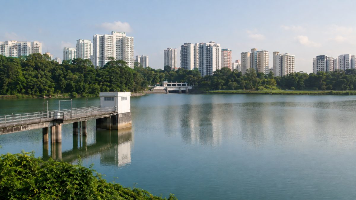 Urban reservoir in Singapore surrounded by high-rise buildings under bright tropical light