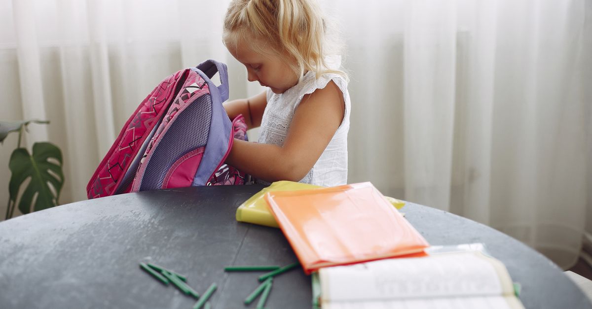 Child preparing a school bag and supplies for the 2026 return to school