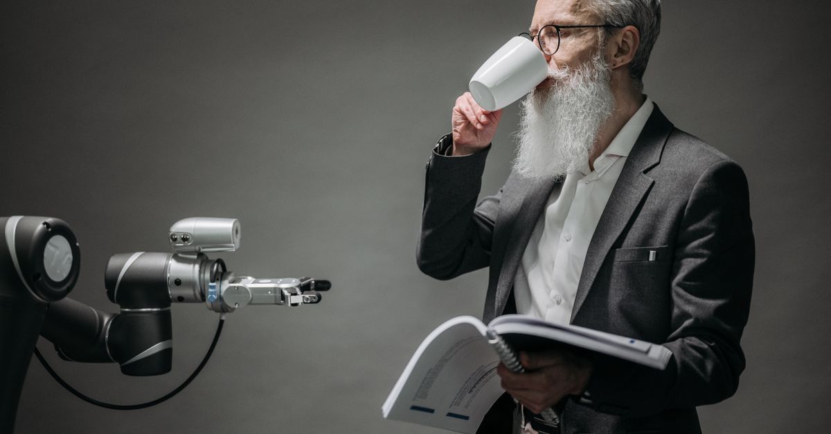 Robot and human working together in a modern office, illustrating the impact of AI on jobs in 2026