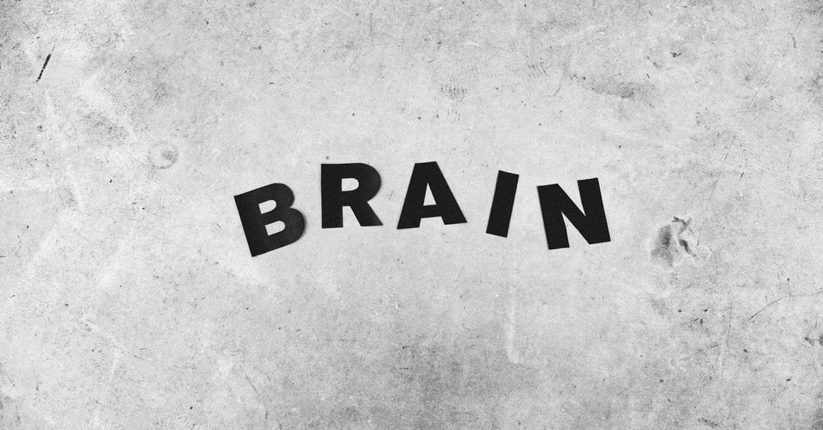 Human brain with floating fragments of memories on a dark and luminous background