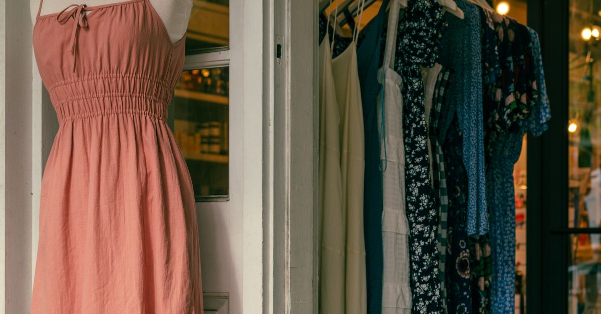 clothes on sale on racks in a shop during the 2026 summer sales in France